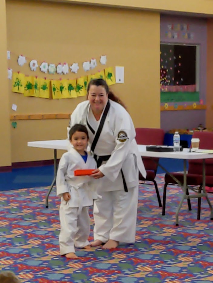 Getting his orange belt at Heritage Black Belt Academy taekwondo